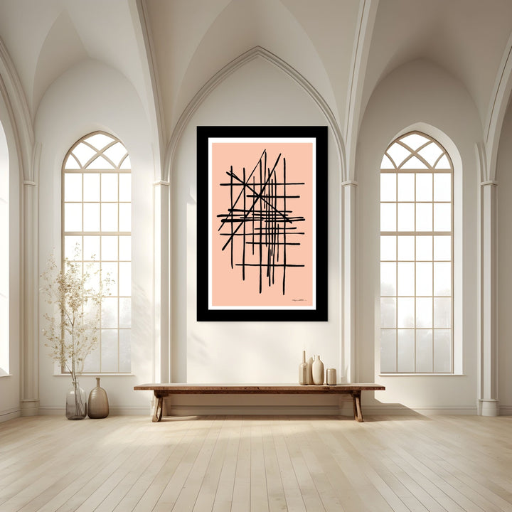 Abstract artwork on a pink background in a room with high ceilings and large windows.