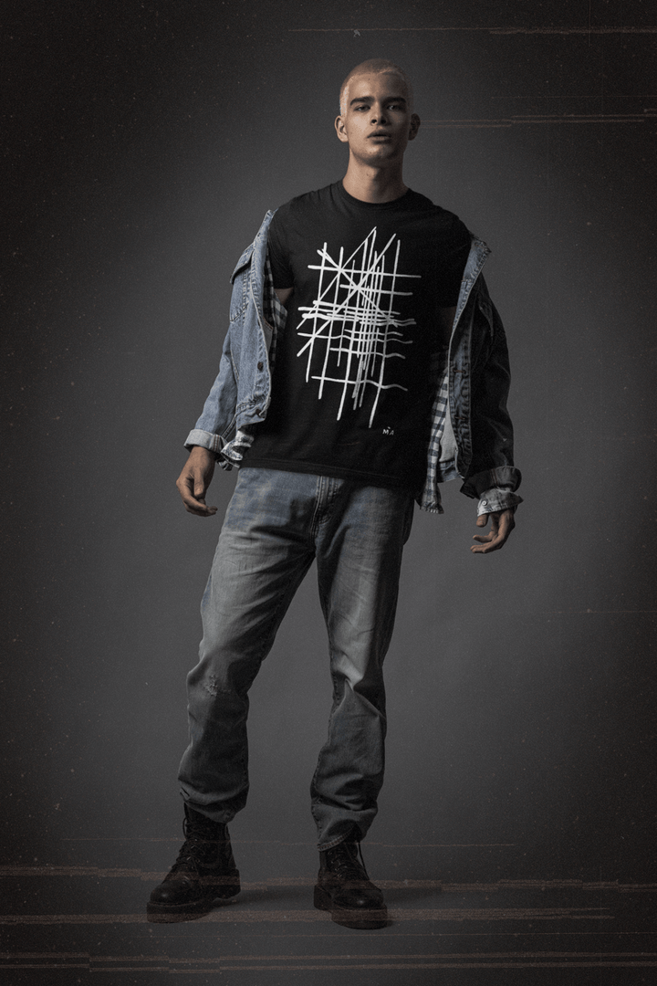 Man wearing a black t-shirt with white abstract graphic design and blue jeans on a dark background