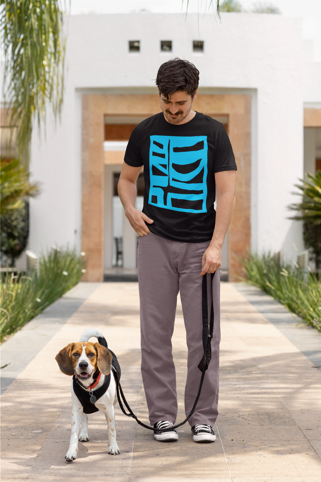 man with a mustache ready to take his dog for a walk wearing abstract t shirt BI 500 in blue