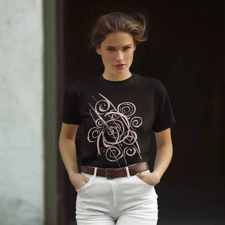 A woman with brown hair pulled back stands with hands in her white pants pockets, wearing the Trend - Abstract T-Shirt from Miamiabstract.com, a black tee featuring a large, intricate light-colored swirling graphic.